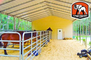 Metal barn crafted from a carport with horse gating inside.