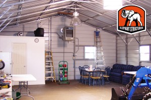 The inside of a metal carport made easy to maintain with after market lights installed.