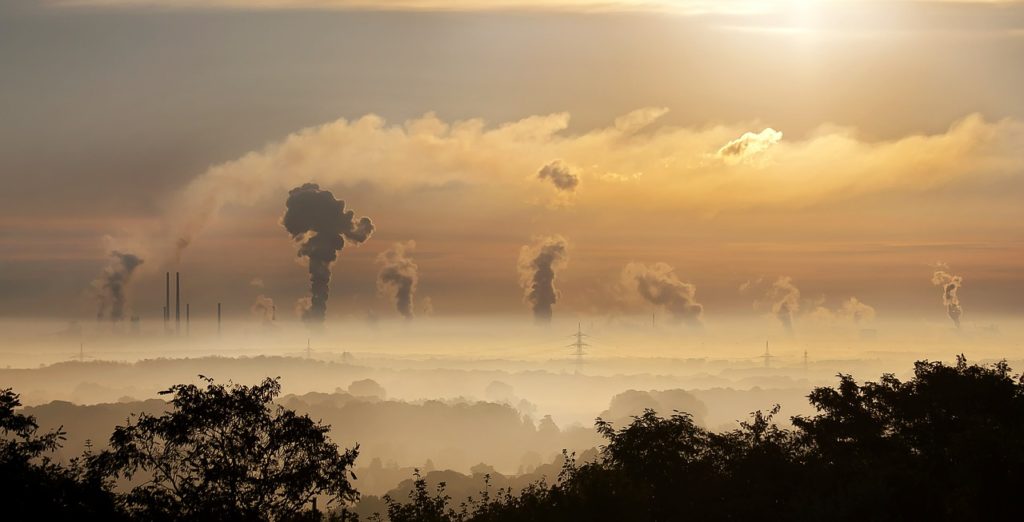 Industry at sunrise with clouds and fog