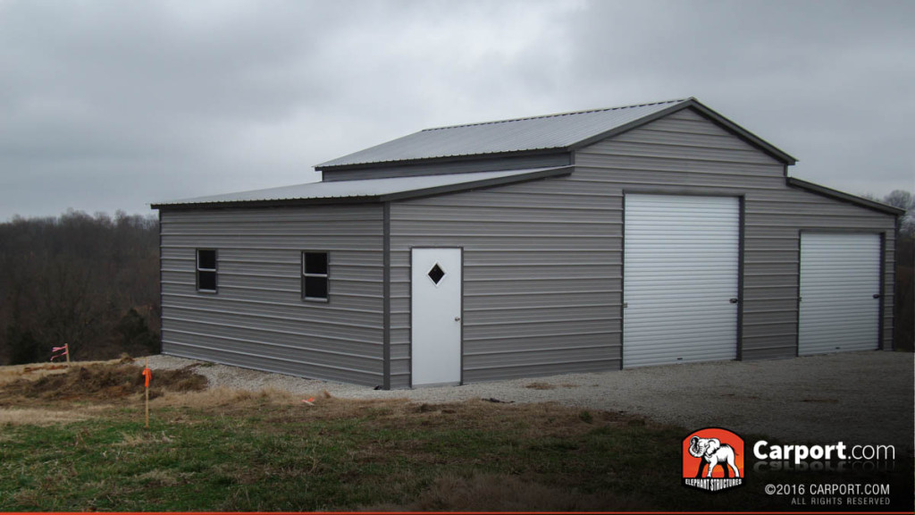 Ridgeline barn used as a metal barn workshop with two garage doors and one man door.