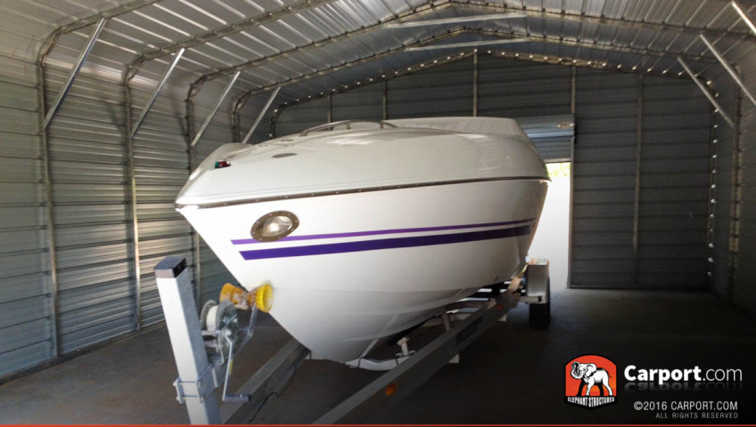 Metal boat cover carport with boat stored inside.