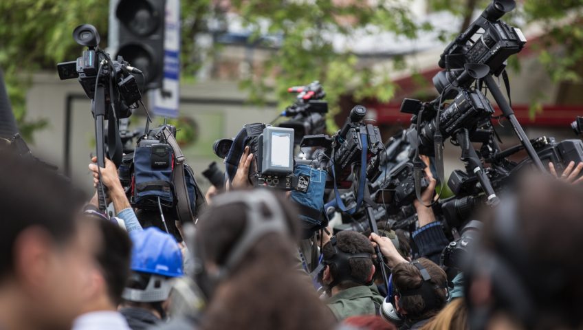 news reporters swarm to get a story