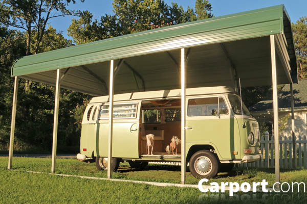 One single wide metal barn with gable ends and van stored underneath.