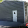 Two car metal garage building with two roll up garage doors and one man door.