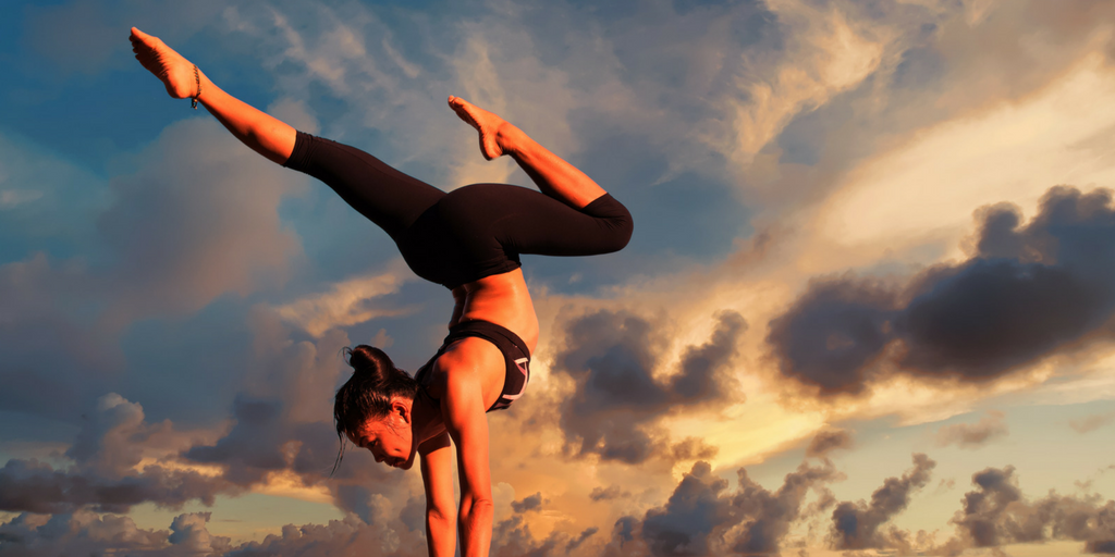 woman doing yoga hand stand